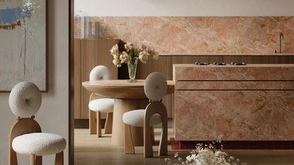 a kitchen with island and backsplash in pink stone