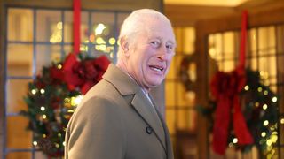 King Charles III smiles during the The King's Foundation's annual 'Crafts at Christmas' at Highgrove Gardens on December 13, 2024