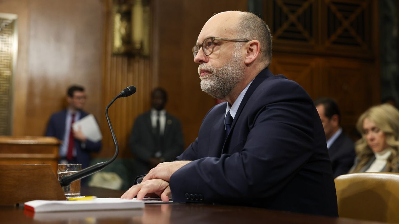 Senate Banking Committee Holds Nomination Hearing For Russell Vought To Be OMB Director with Vought dressed in a blue suit at a microphone