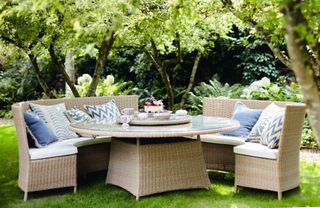 A rattan dining set in a country meadow
