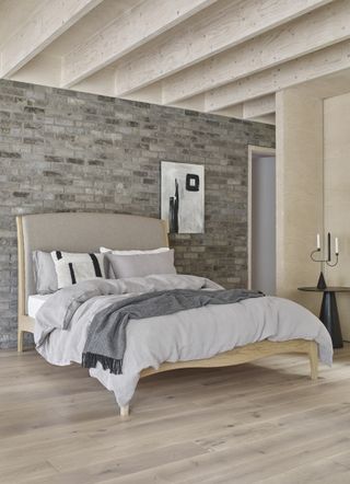 bedroom with pale wood floor and double bed
