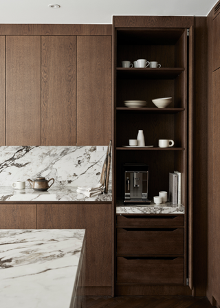 a dark wood kitchen with a single door breakfast cupboard