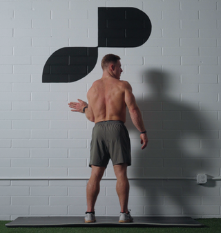 Noah Ohlsen performing the PNF shoulder external rotation two-way stretch