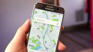 The Uber app open on a smartphone held by a hand