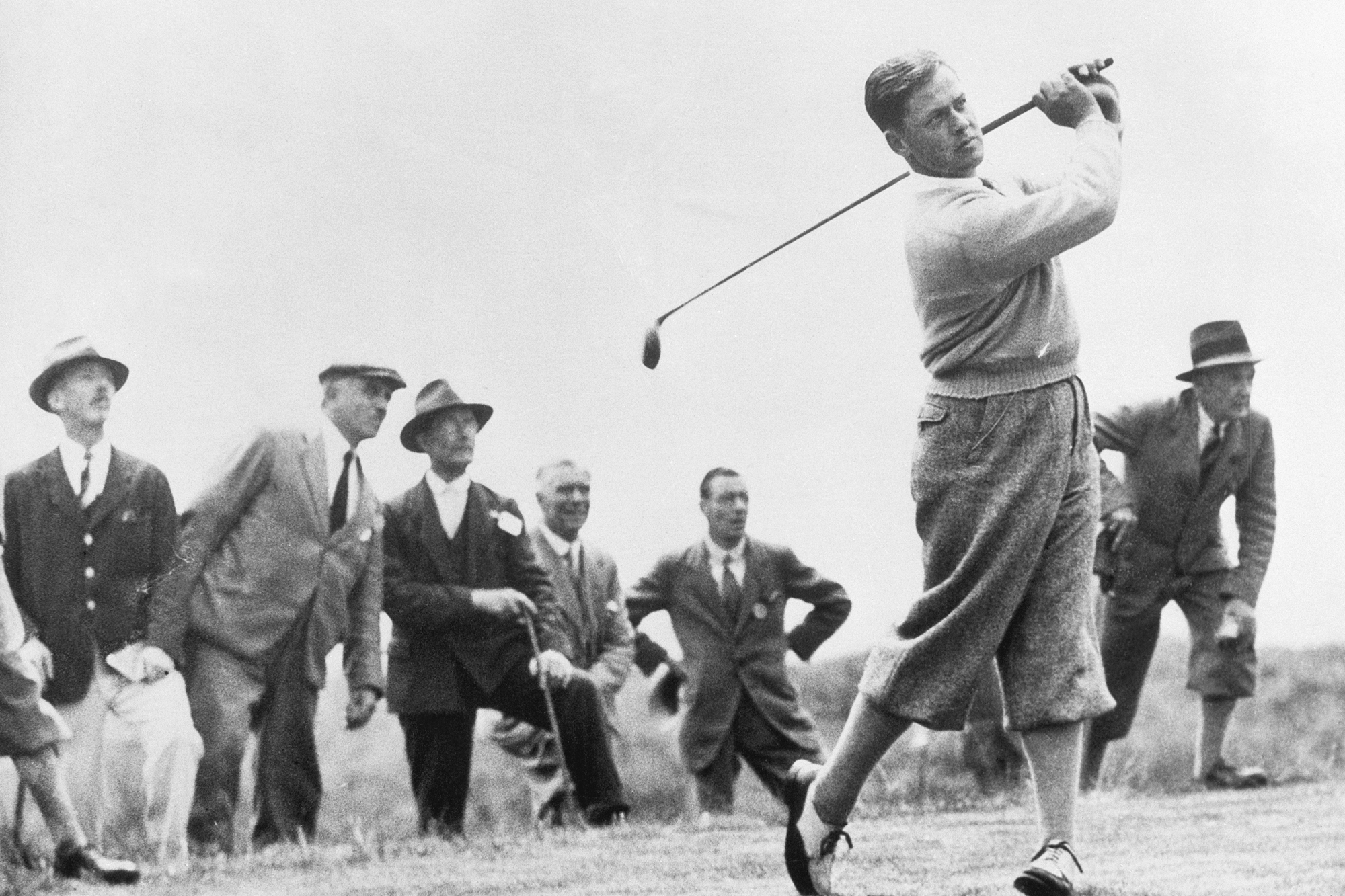 Bobby Jones hitting a golf shot at the 1930 Open Championship in front of a group of fans