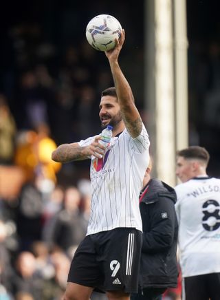 Aleksandar Mitrovic celebrates with the match ball after after his hat-trick against West Brom in October
