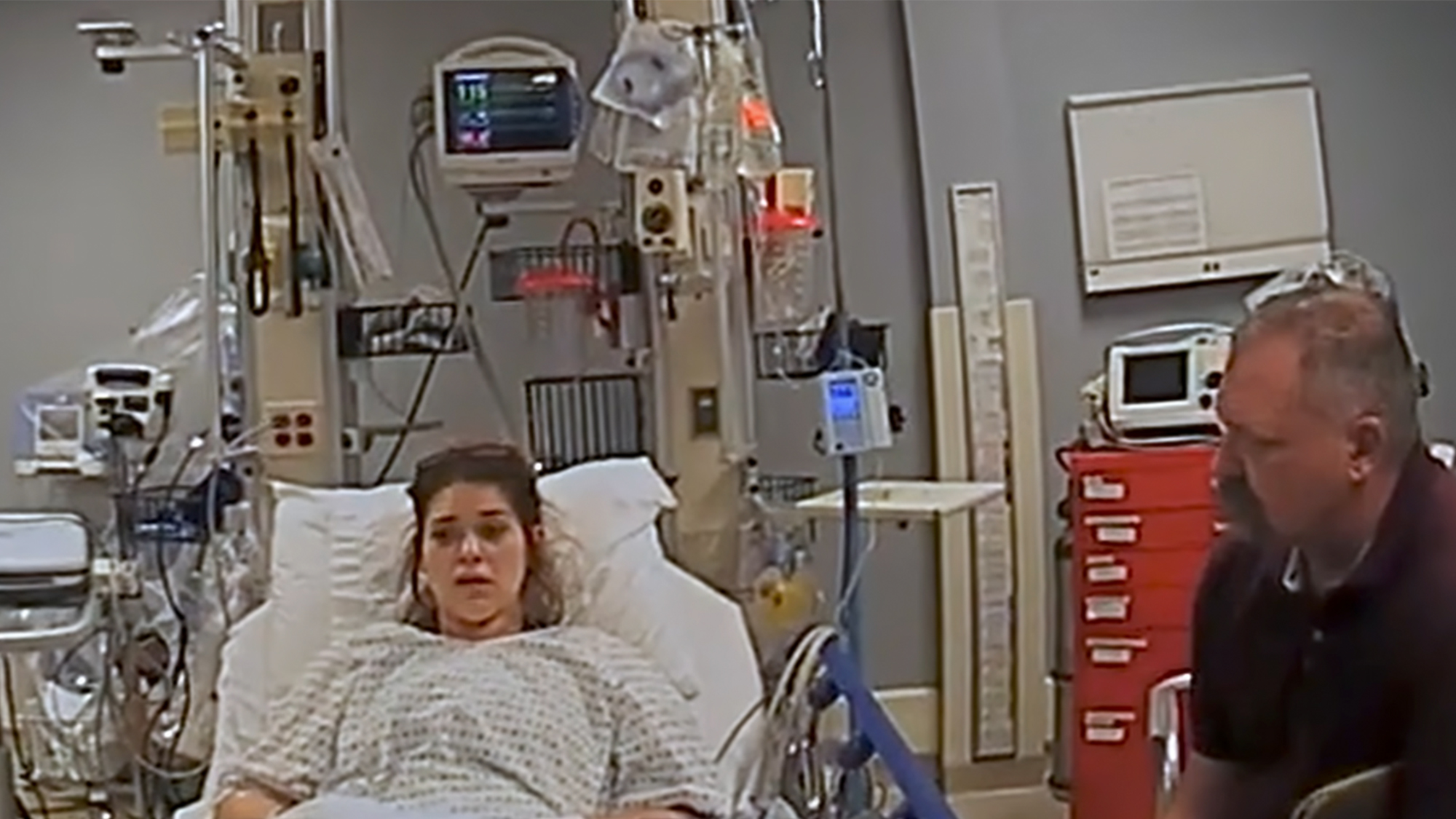 Bodycam footage of a police detective interview Taylor Parker in a hospital bed.