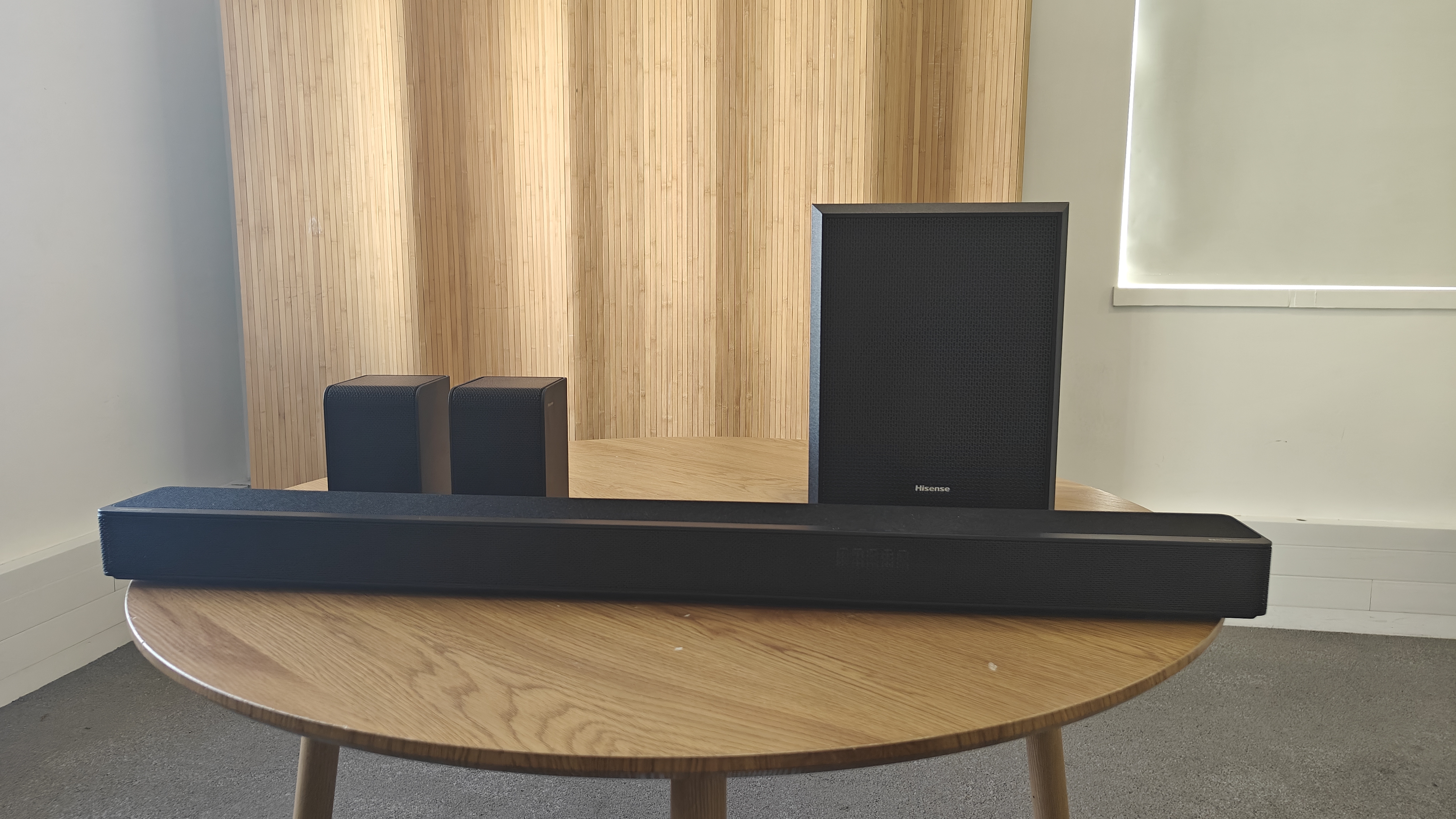Hisense AX5125H soundbar system on a round brown table