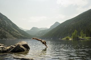 woman diving into lake