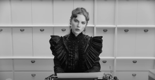 Taylor Swift performs her single "Fortnight" wearing a strong shouldered Victorian top