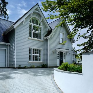 new england style home with cladding and block paving driveway image by nigel rigden