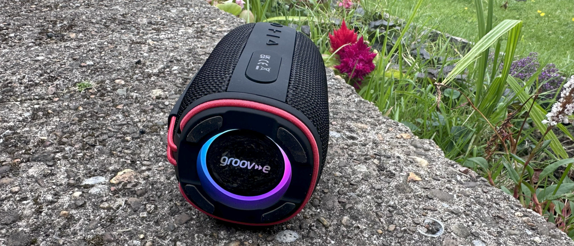 Groov-e&#039;s Wave Glow with illuminated ELD lights on it&#039;s end, lying on its side in a garden