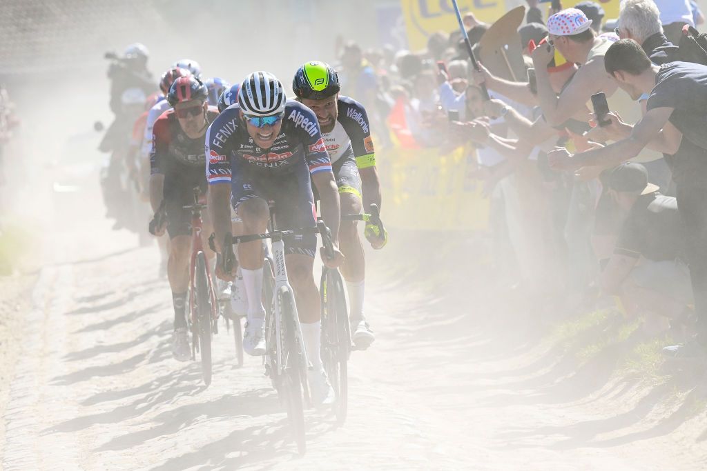 ROUBAIX FRANCE APRIL 17 LR Mathieu Van Der Poel of Netherlands and Team AlpecinFenix and Adrien Petit of France and Team Intermarch Wanty Gobert Matriaux compete passing through a dusty cobblestones sector during the 119th ParisRoubaix 2022 Mens Elite a 2572km one day race from Compigne to Roubaix ParisRoubaix WorldTour on April 17 2022 in Roubaix France Photo by Bernard Papon PoolGetty Images