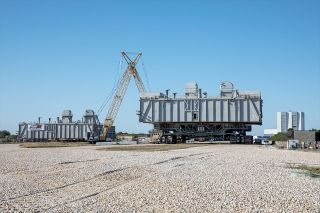 Two mobile launch platforms (MLPs) are seen at the mobile service structure park site at NASA's Kennedy Space Center in Florida on Jan. 4, 2021. MLP-2, at left, is being demolished while MLP-1 is being used to condition the rock-covered crawlerway for the Space Launch System (SLS) rocket.