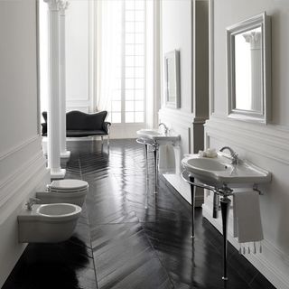 White basin and loo with dark wood floor