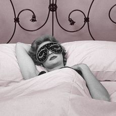 Woman wearing sleep mask getting beauty sleep