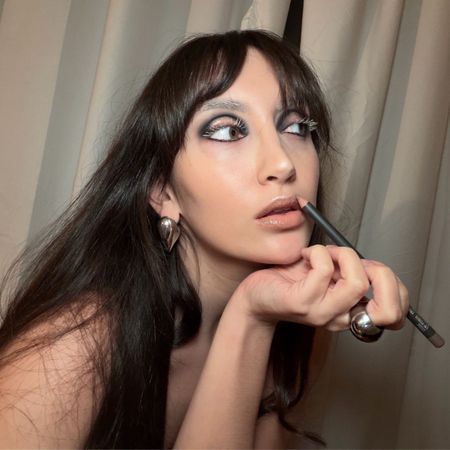 An image of WWW associate beauty editor Alyssa Brascia wearing the bleached brow trend. 