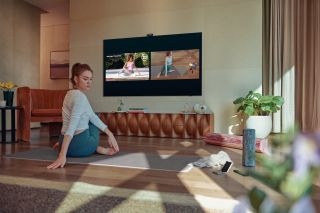 Woman sitting in front of samsung TV on floor