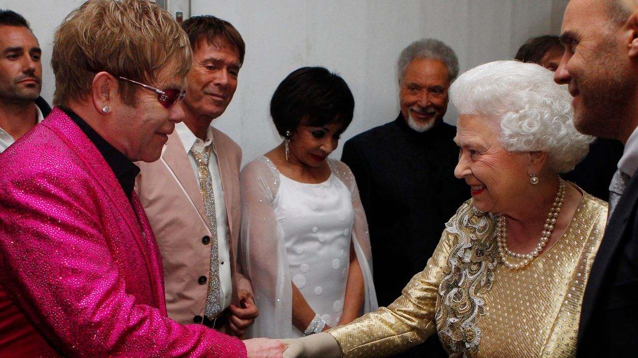 LONDON, UNITED KINGDOM - JUNE 04: Queen Elizabeth ll meets Sir Elton John during The Diamond Jubilee Concert in front of Buckingham Palace on June 4, 2012 in London, England. 