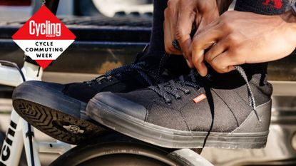 Cyclist tying up the laces of Chrome Industries' shoes which are among the best shoes for cycle commuters