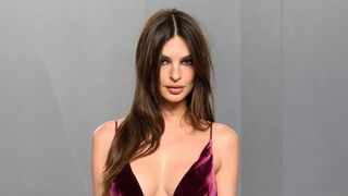 Emily Ratajkowski at the 2026 Vanity Fair Oscars after party. Here, she's in a v-cut burgundy ballgown.
