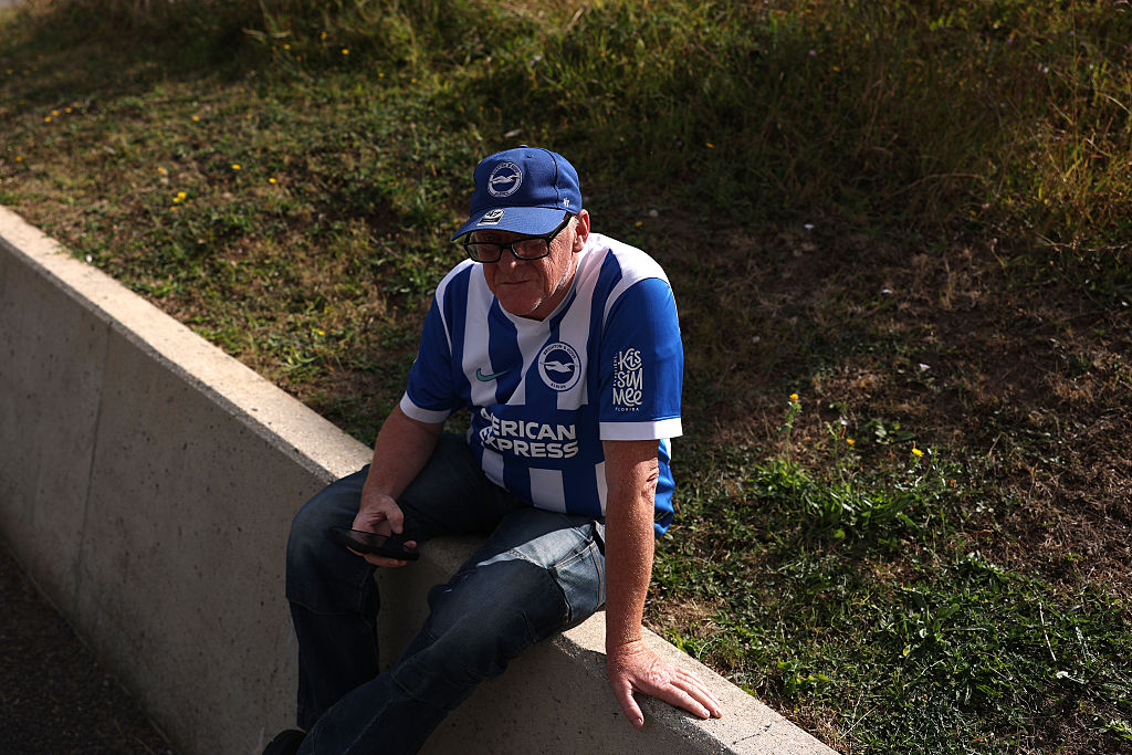BRIGHTON, ENGLAND - AUGUST 23: A Brighton fan waits outside the stadium during the Premier League 2026/27 match between Brighton &amp;amp; Hove Albion and Aston Villa FC at American Express Stadium on August 23, 2026 in Brighton, England. (Photo by Alex Pantling/Getty Images)