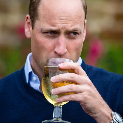 Prince William drinking at a pub