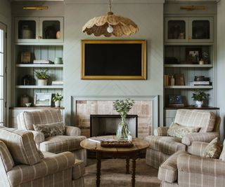 farmhouse style soft green panelled living room with alcove shelf storage