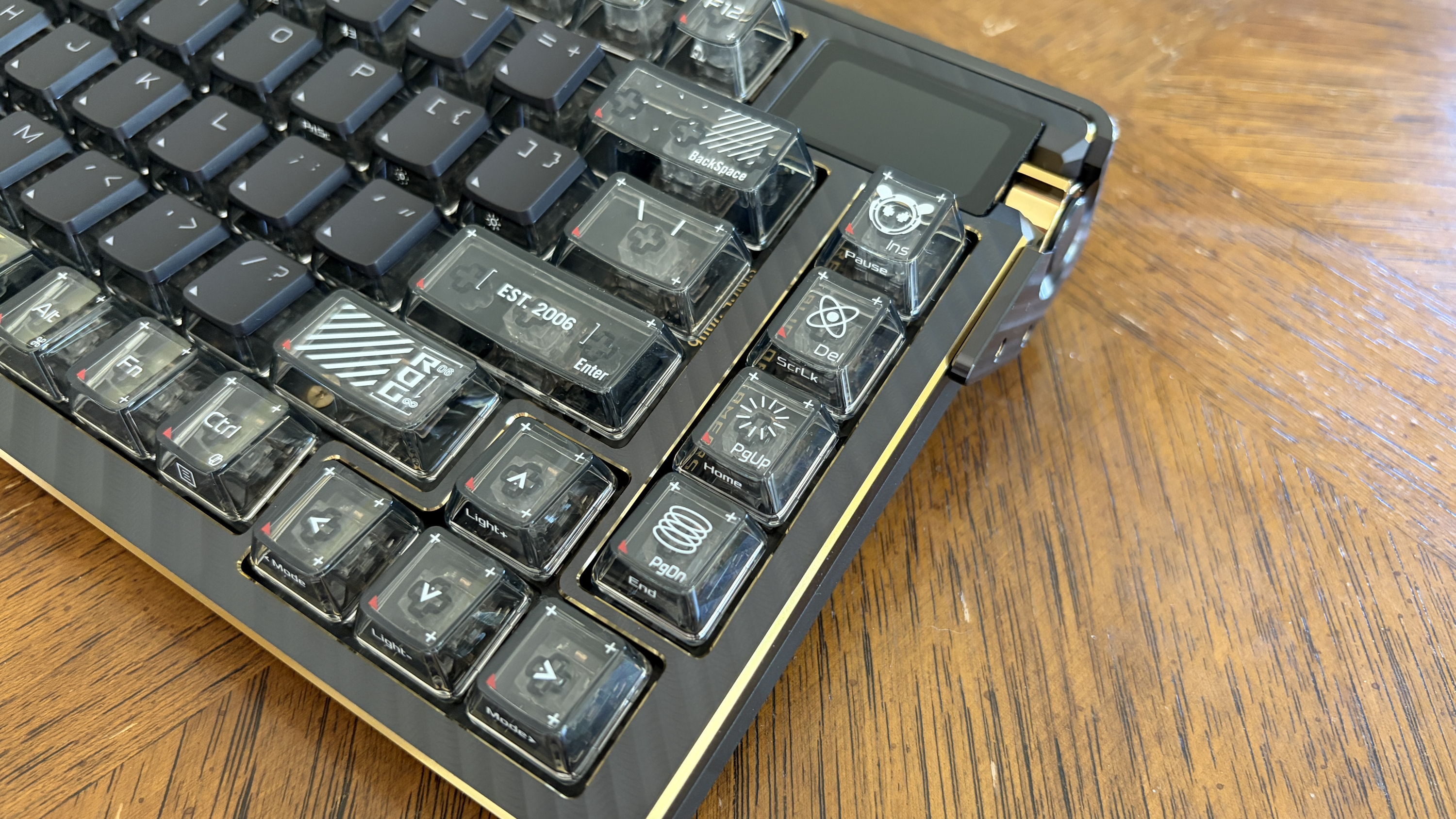 Close-up of an ASUS ROG Azoth Extreme Edition 20 mechanical keyboard with transparent keycaps and golden accents.
