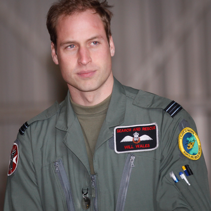 rince William waits for his grandmother Queen Elizabeth II to arrive for an offical visit to RAF Valley where Prince William is stationed as a search and rescue helicopter pilot on April 1, 2011 in Holyhead, United Kingdom. The Queen toured the airbase meeting staff and families and was given a guided tour of a Sea King search and rescue helicopter by Prince William