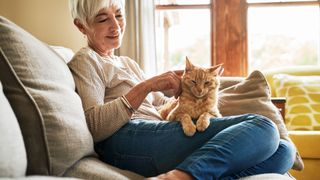 Woman sitting with cat on her lap