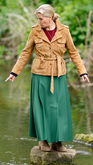 Sophie, Duchess of Edinburgh seen using stepping stones to cross a stream as she attends day 3 of the 2023 Royal Windsor Horse Show