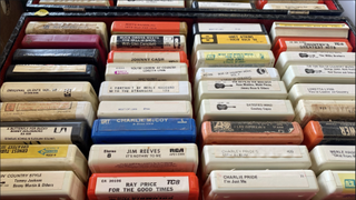 A crate of 8-track cartridges in a store
