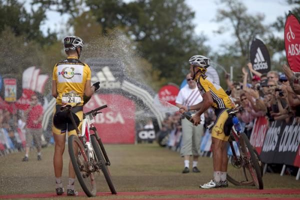 Christoph Sauser and Burry Stander let the champagne fly