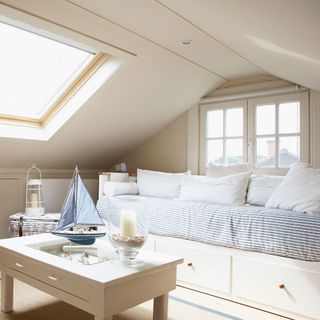 attic bedroom with white pastel colour wall and coffee table