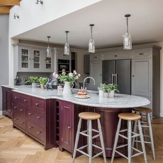 kitchen with overhead lamps and counter with stools