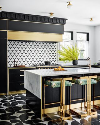 black and white kitchen with marble and brass kitchen island