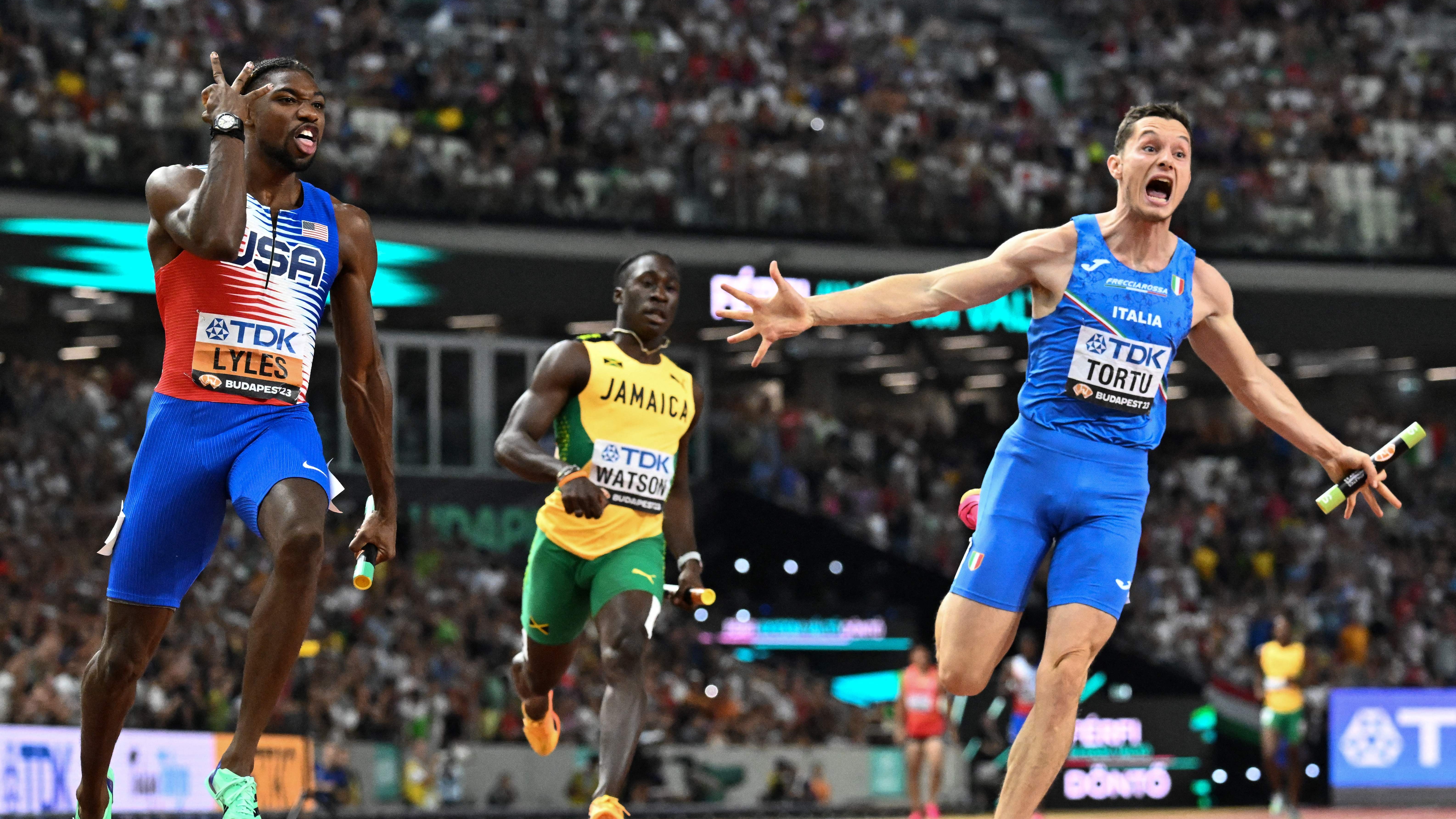 USA's Noah Lyles and Italy's Filippo Tortu react after the men's 4x100m relay final during the World Athletics Championships at the National Athletics Centre in Budapest on August 26, 2023. 