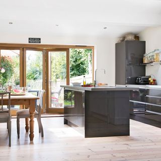 open plan kitchen with black counter with dining table