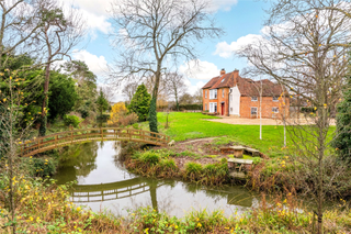 house with bridge country property for sale