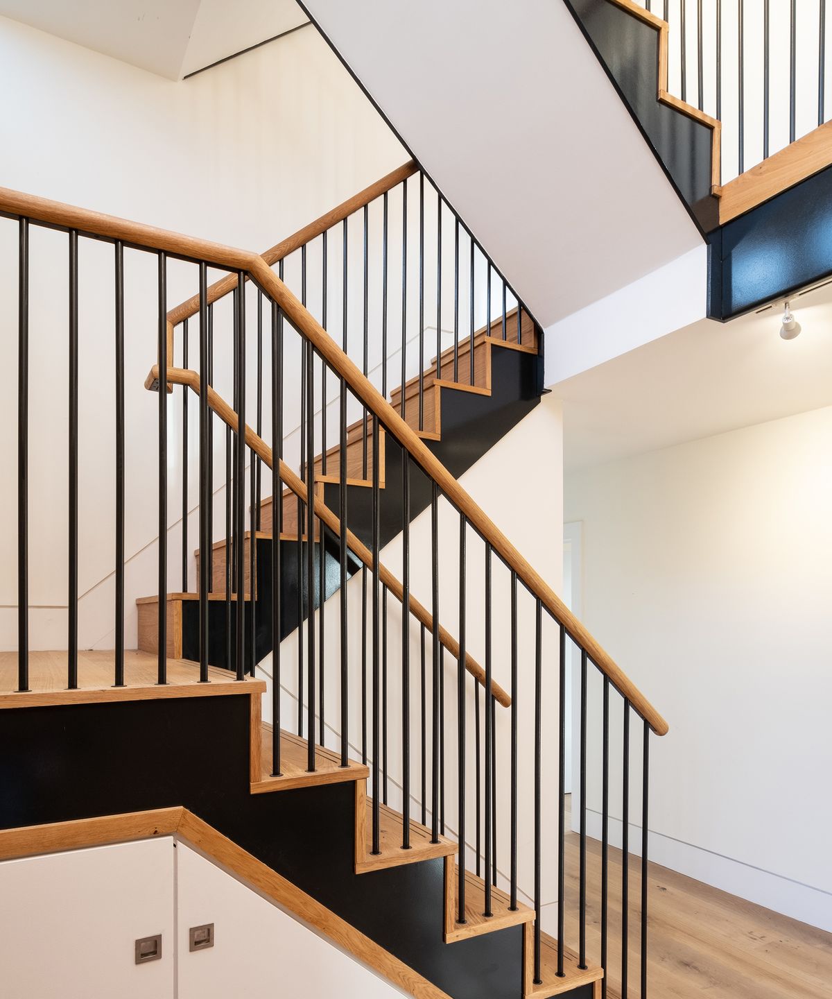 a new staircase with metal banisters and wooden hand rails