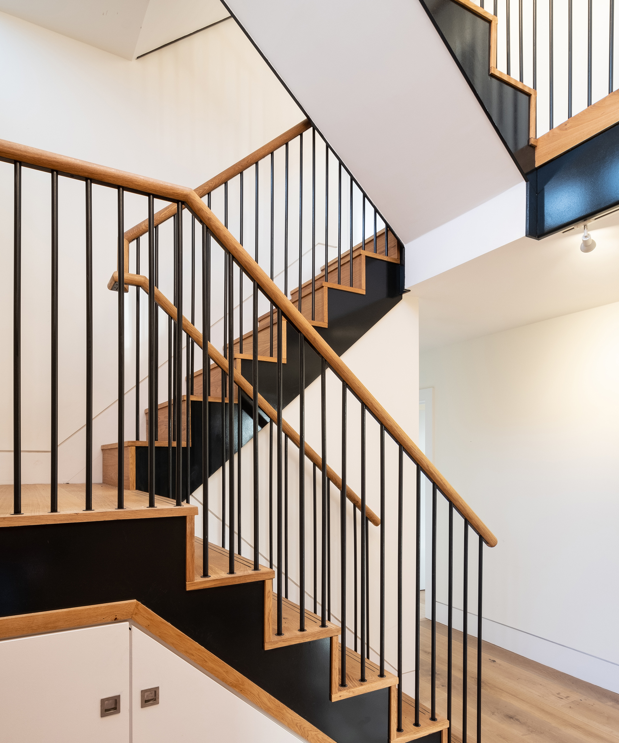 a new staircase with metal banisters and wooden hand rails