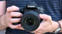 The Canon EOS 90D being held in two hands