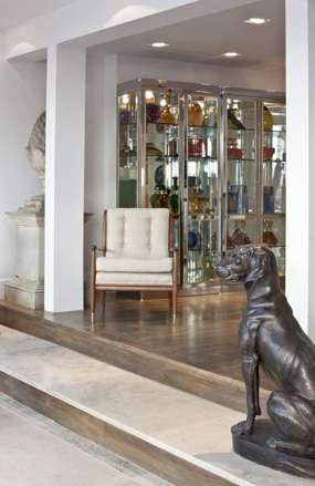 American armchair upholstered in contemporary fabric and a pair of nickel glazed display cabinets