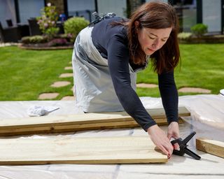 Melanie Lissack arranging wood panels on grass - jeyes fluid