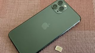 Midnight Green iPhone 11 Pro with a SIM card
