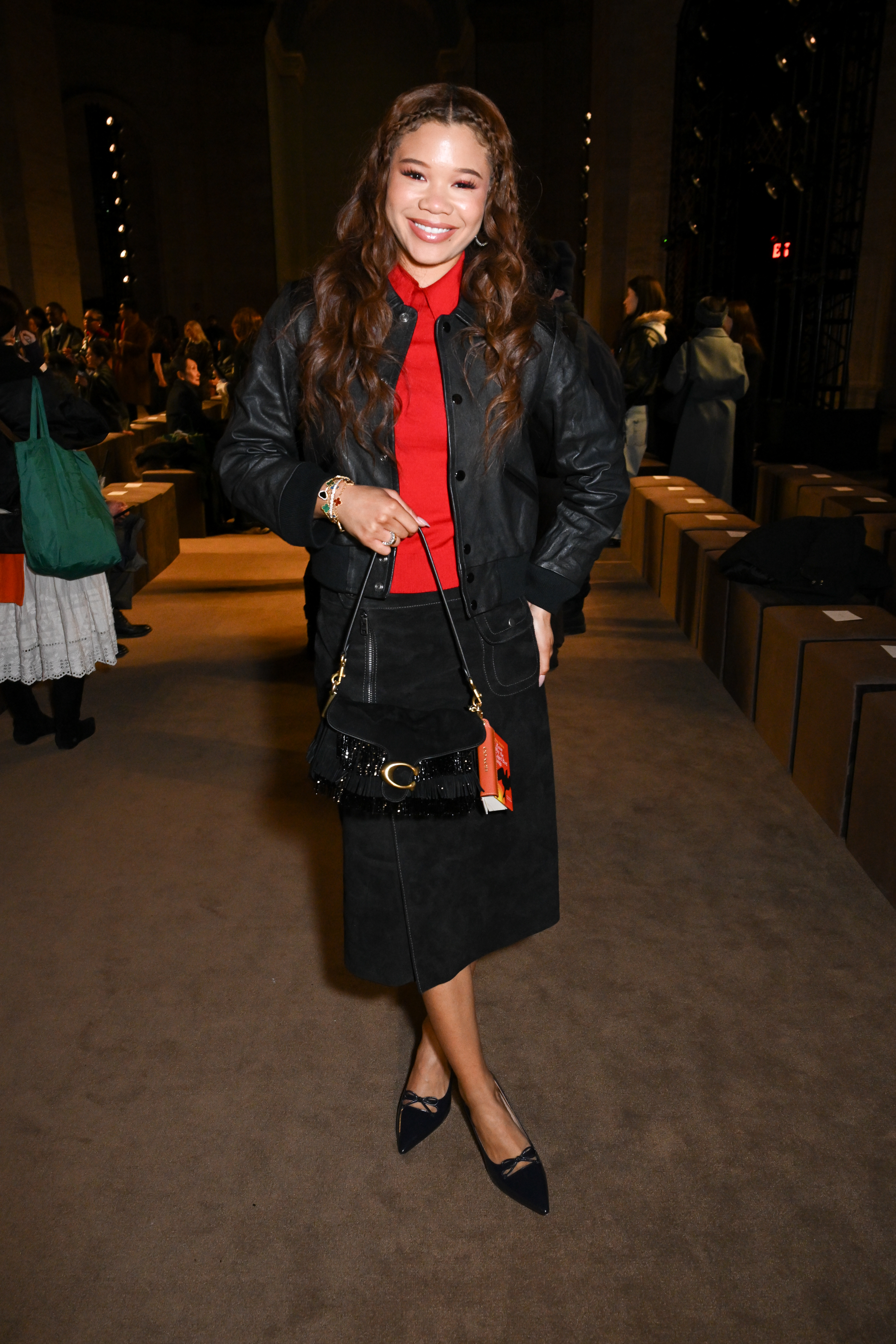 Storm Reid attended the Coach Fall 2026 show with a fringed Coach Tabby bag and a book bag charm