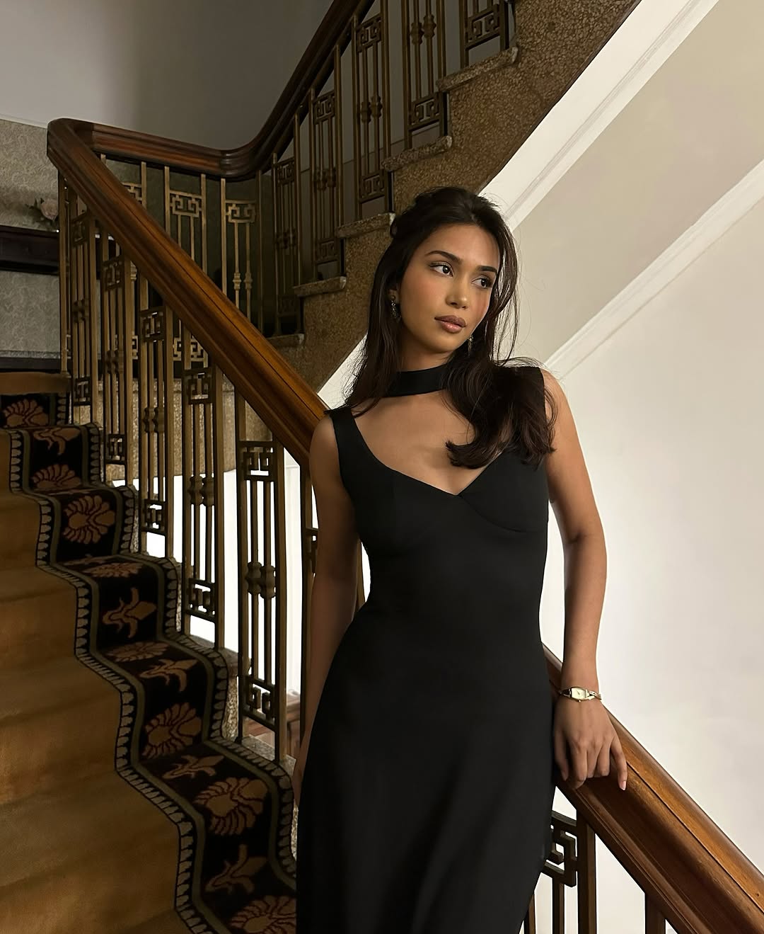 Mishti Rahman with glossy, gently curled hair, and bronzed makeup