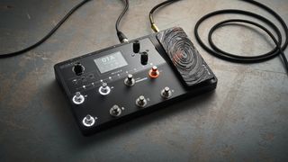 A Mooer GE150 Max Li multi-effects pedal on a concrete floor