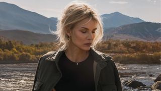 Michelle Pfeiffer stands in front of a Montana mountain range